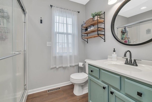 141 Scott Ave, Oglesby, IL 61348 - full bathroom with baseboards, wood finished floors, visible vents, and a stall shower