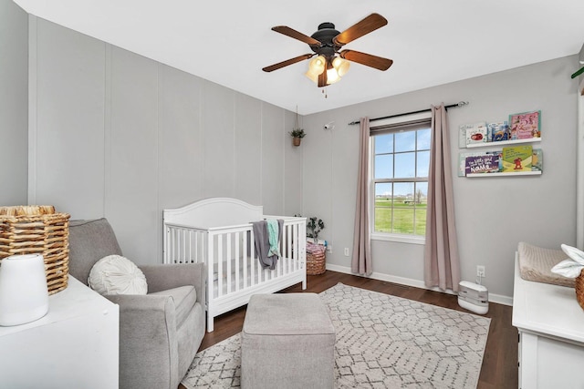141 Scott Ave, Oglesby, IL 61348 - bedroom featuring a crib, baseboards, wood finished floors, and ceiling fan