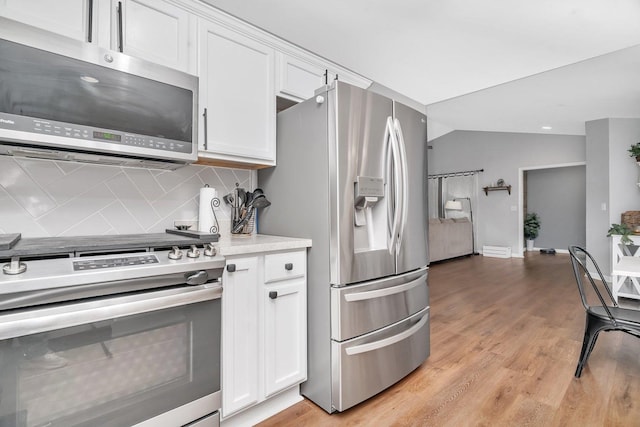 141 Scott Ave, Oglesby, IL 61348 - kitchen featuring light countertops, decorative backsplash, white cabinetry, and stainless steel appliances