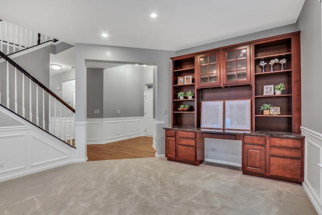 unfurnished office featuring recessed lighting, a decorative wall, a wainscoted wall, and light carpet