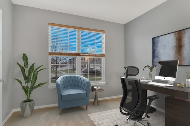 carpeted home office featuring baseboards and plenty of natural light