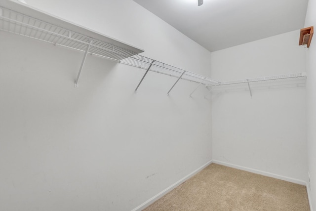 walk in closet with light carpet and visible vents