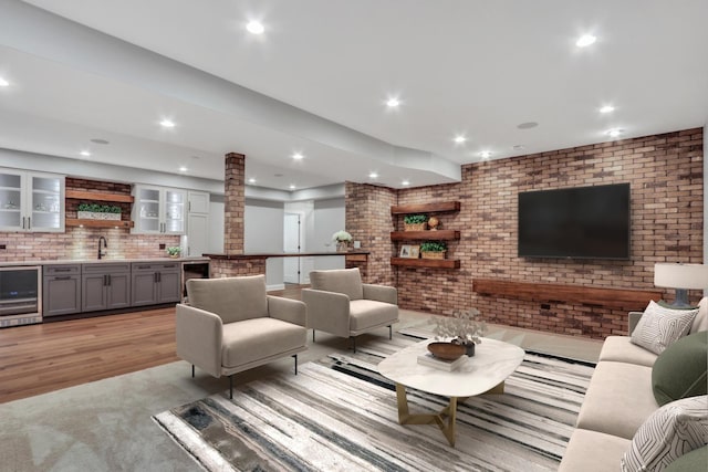 living room with recessed lighting, beverage cooler, and decorative columns