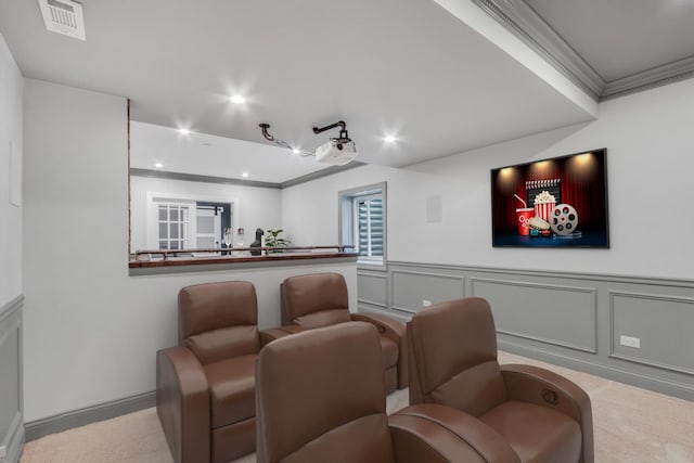 cinema with a decorative wall, crown molding, wainscoting, visible vents, and recessed lighting