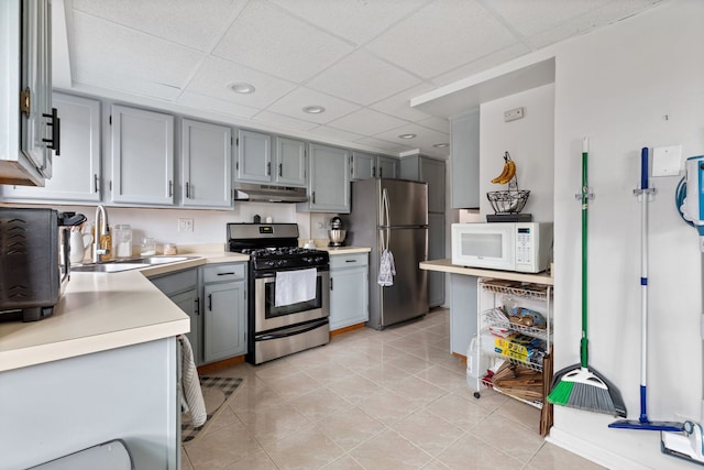 6443 Oak Forest Ave Unit 1W, Tinley Park, IL 60477 - kitchen with a sink, appliances with stainless steel finishes, light countertops, under cabinet range hood, and gray cabinetry