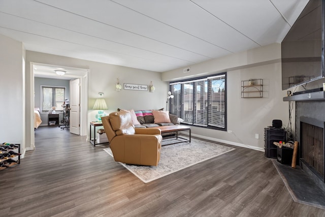 6443 Oak Forest Ave Unit 1W, Tinley Park, IL 60477 - living room featuring dark wood-type flooring, a fireplace with raised hearth, baseboards, and visible vents
