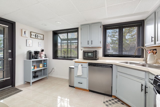 6443 Oak Forest Ave Unit 1W, Tinley Park, IL 60477 - kitchen with stainless steel dishwasher, a sink, light tile patterned flooring, baseboards, and a paneled ceiling
