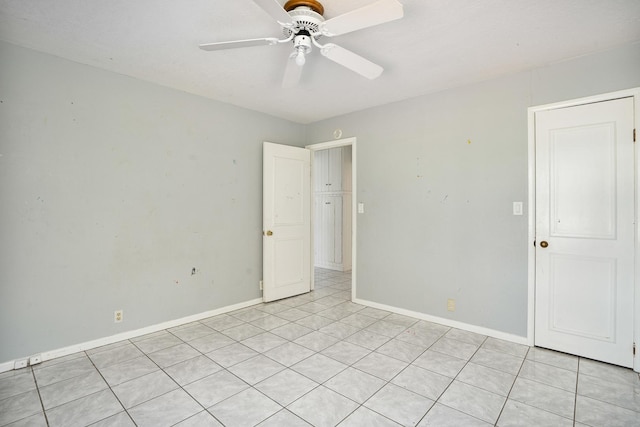 unfurnished room with baseboards and a ceiling fan