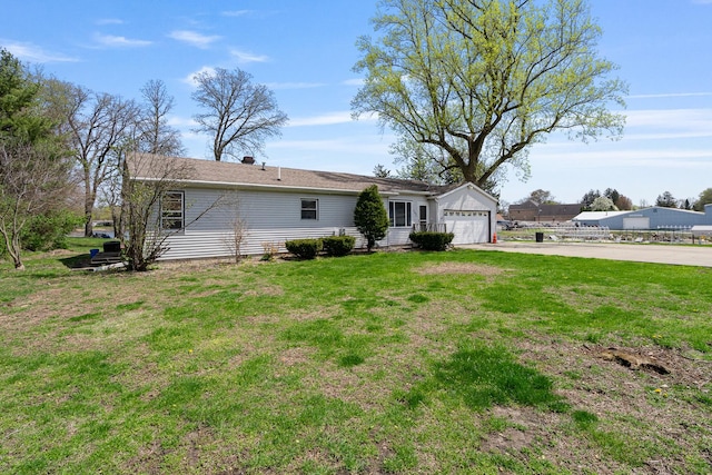 exterior space featuring a lawn and concrete driveway