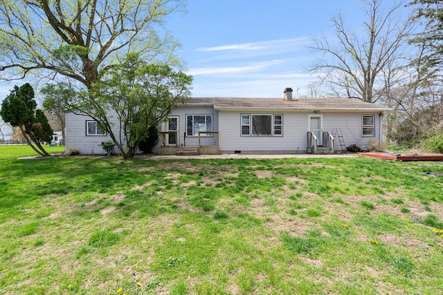 rear view of property featuring a lawn