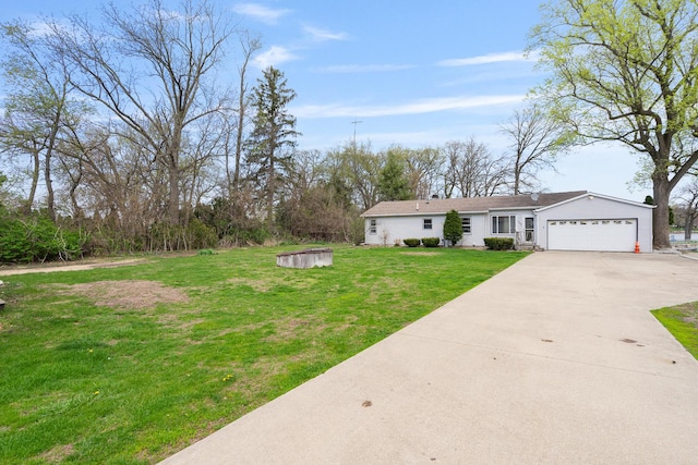 view of front of home featuring concrete driveway, a front yard, and a garage