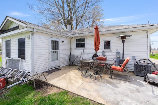 rear view of property featuring central AC unit and a patio