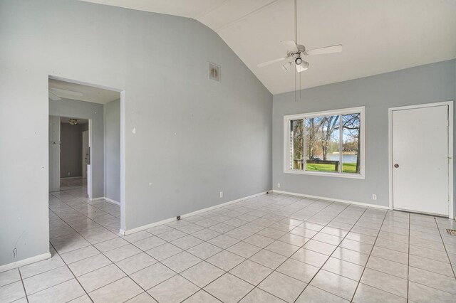 unfurnished room featuring baseboards, a ceiling fan, high vaulted ceiling, and light tile patterned floors