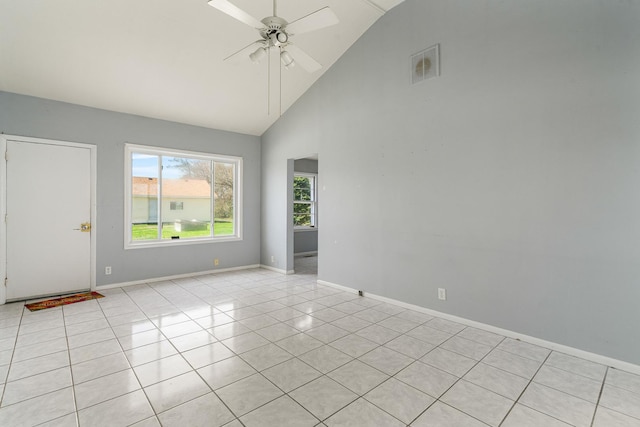 empty room featuring high vaulted ceiling, a ceiling fan, light tile patterned floors, baseboards, and visible vents