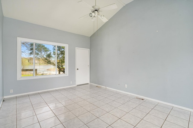 spare room with light tile patterned floors, baseboards, high vaulted ceiling, and ceiling fan