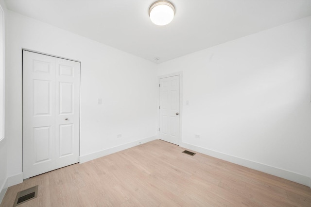 3246 S Normal Ave, Chicago, IL 60616 - unfurnished bedroom with light wood finished floors and a closet