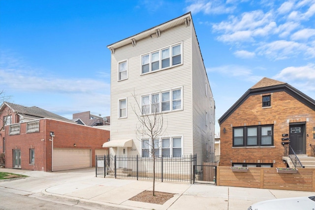 3246 S Normal Ave, Chicago, IL 60616 - view of front of property with a fenced front yard, a gate, concrete driveway, and brick siding