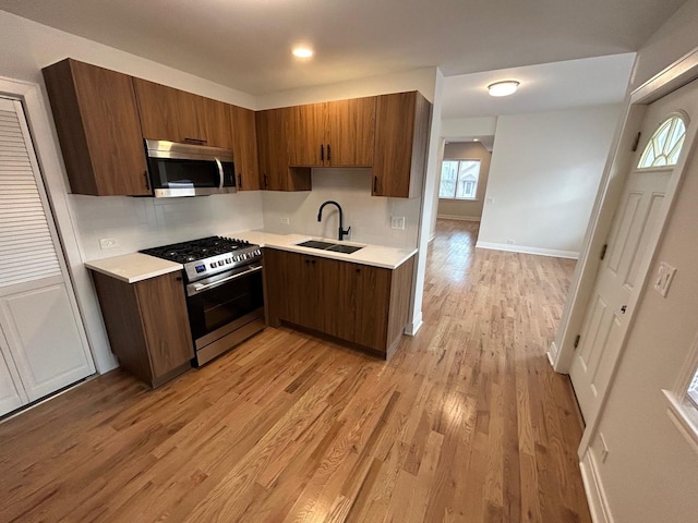 3246 S Normal Ave, Chicago, IL 60616 - kitchen with stainless steel appliances, light countertops, light wood finished floors, and backsplash