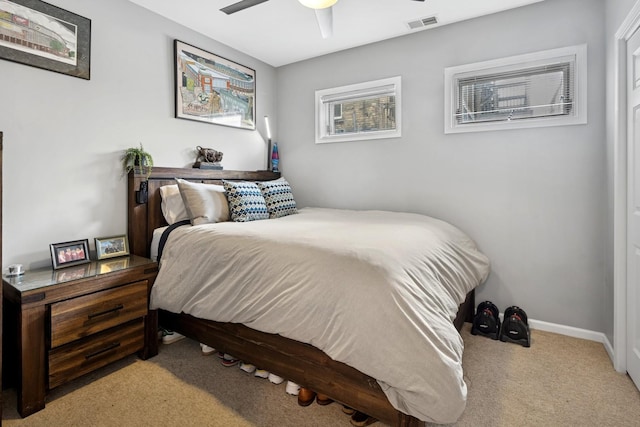 carpeted bedroom featuring baseboards and ceiling fan