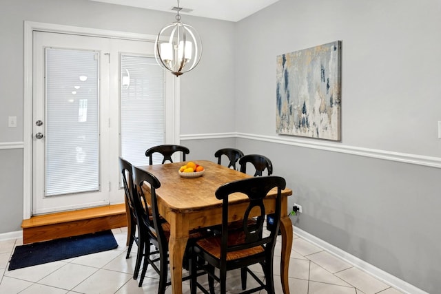 dining area featuring light tile patterned flooring, baseboards, and a chandelier