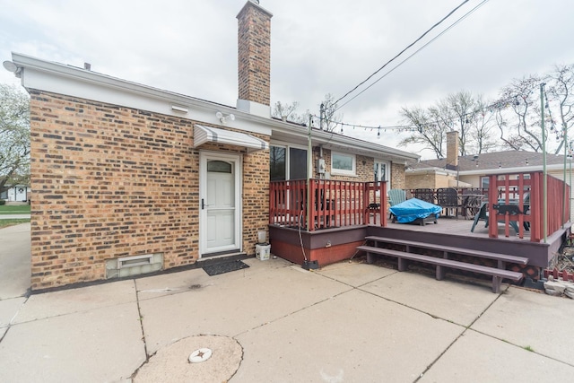8212 N Ozanam Ave, Niles, IL 60714 - back of property with brick siding, a patio area, a chimney, and a deck