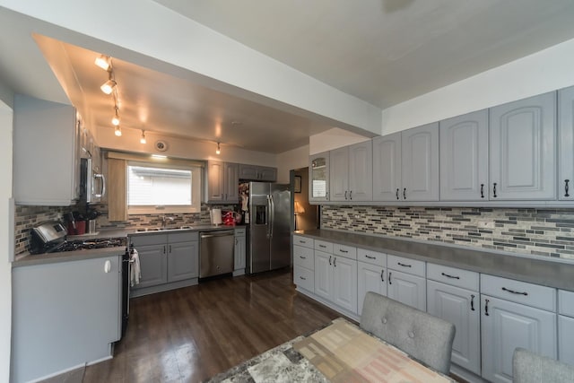 8212 N Ozanam Ave, Niles, IL 60714 - kitchen with a sink, decorative backsplash, gray cabinets, appliances with stainless steel finishes, and dark wood-style floors