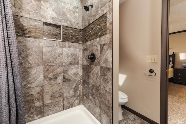 ensuite bathroom with ensuite bath, a tile shower, toilet, and baseboards