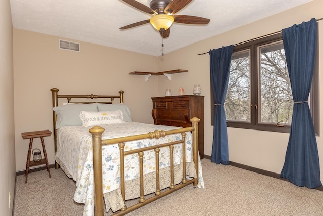 bedroom featuring visible vents, carpet flooring, baseboards, and a ceiling fan