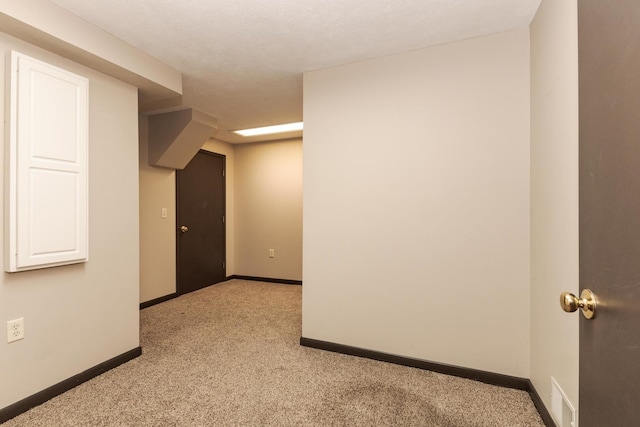 empty room with light carpet, visible vents, and baseboards