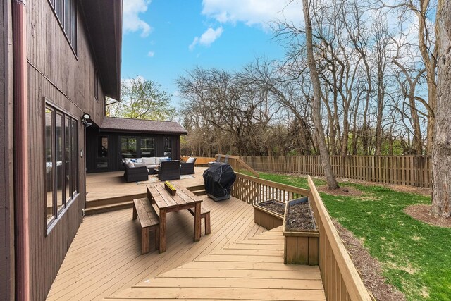 wooden terrace with a lawn, a fenced backyard, outdoor lounge area, and area for grilling