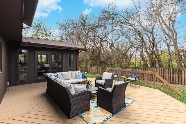 deck with a fenced backyard and an outdoor hangout area