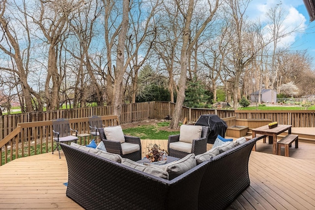 wooden terrace featuring a fenced backyard and an outdoor living space