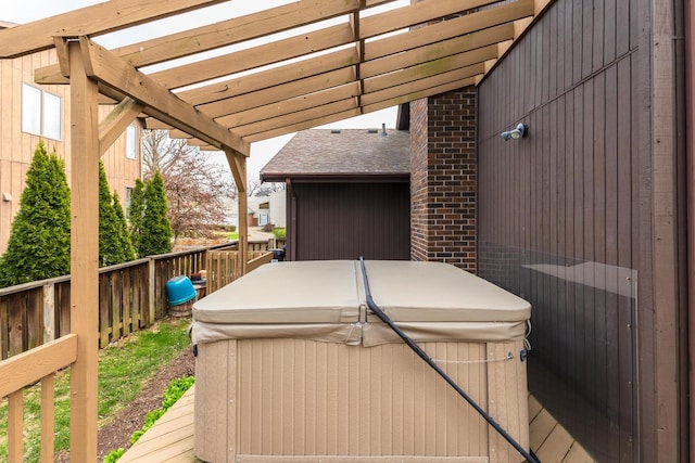 wooden terrace featuring a hot tub