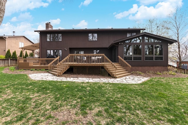 back of house with fence, a chimney, a yard, and a deck