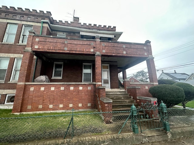 view of front of property with brick siding and fence private yard