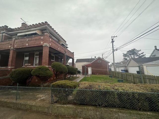 view of property exterior featuring fence private yard and brick siding