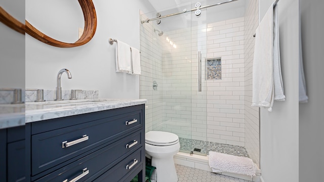 full bath featuring a shower stall, toilet, vanity, and tile patterned floors