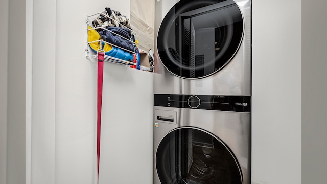 washroom with stacked washing machine and dryer