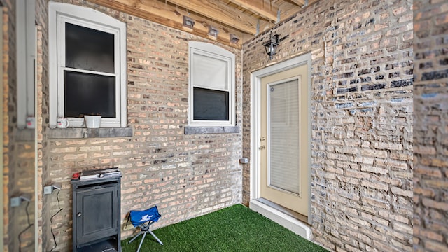 entrance to property featuring brick siding