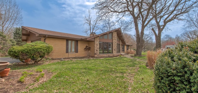3515 Partridge Ln, Belvidere, IL 61008 - view of side of property featuring a chimney, brick siding, and a yard
