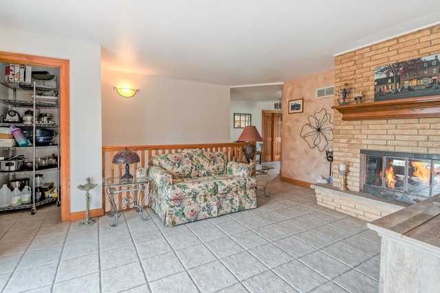 3515 Partridge Ln, Belvidere, IL 61008 - tiled living room with baseboards, a brick fireplace, and visible vents