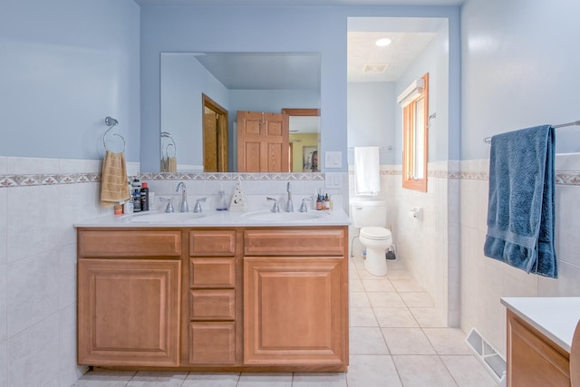 3515 Partridge Ln, Belvidere, IL 61008 - bathroom featuring tile patterned floors, a sink, tile walls, double vanity, and visible vents