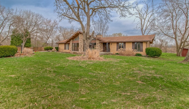 3515 Partridge Ln, Belvidere, IL 61008 - back of house with a yard, a chimney, and fence