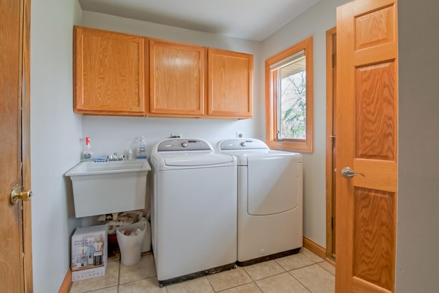 3515 Partridge Ln, Belvidere, IL 61008 - laundry area featuring washer and dryer, cabinet space, a sink, and light tile patterned floors