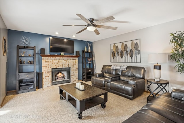 carpeted living area with ceiling fan, recessed lighting, and a fireplace