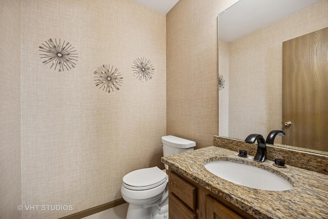 half bath featuring toilet and vanity