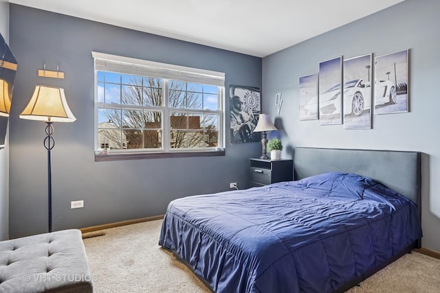 bedroom with carpet floors, visible vents, and baseboards