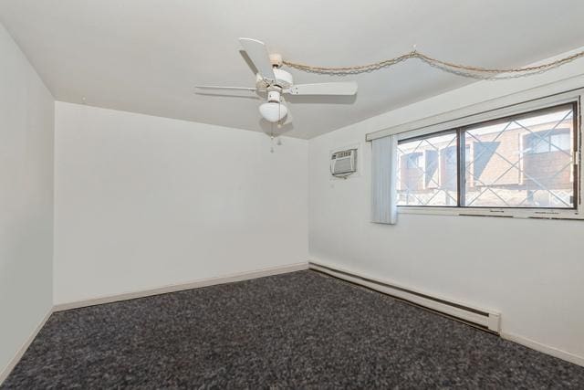 spare room featuring carpet flooring, a wall unit AC, baseboards, baseboard heating, and ceiling fan