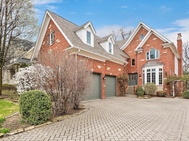 522 N Grant St, Hinsdale, IL 60521 - traditional-style house featuring brick siding, roof with shingles, decorative driveway, and a garage