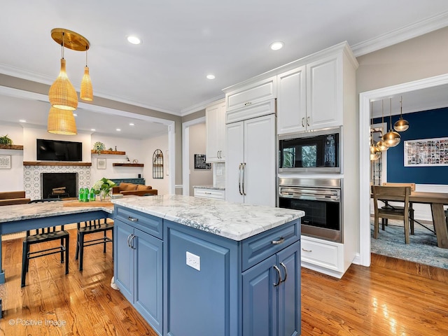 522 N Grant St, Hinsdale, IL 60521 - kitchen featuring light wood-type flooring, white cabinetry, built in appliances, blue cabinetry, and ornamental molding